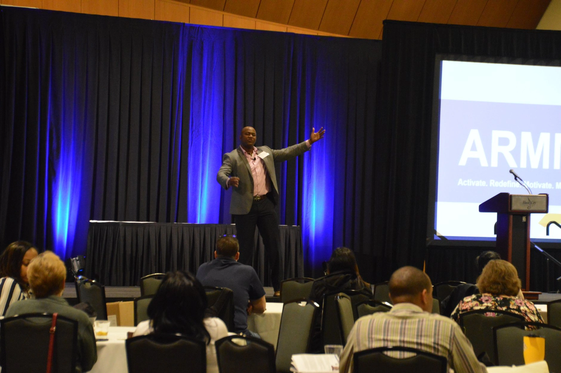 Patrick speaking on stage at PMI Nashville